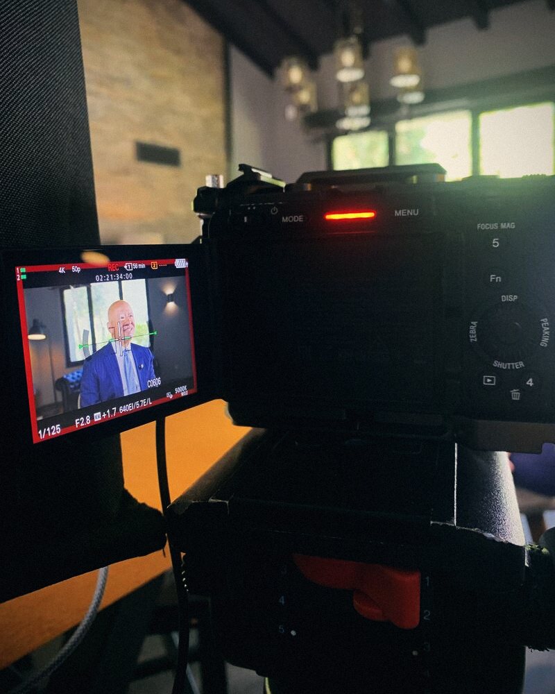 Camera monitor showing an executive interview being recorded
