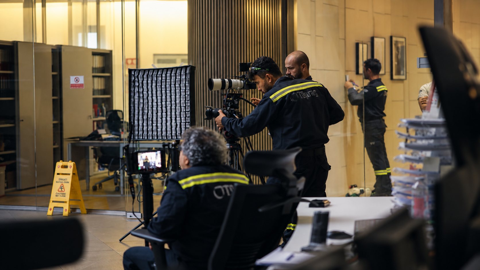 Crew filming in an office with a softbox and two cameras